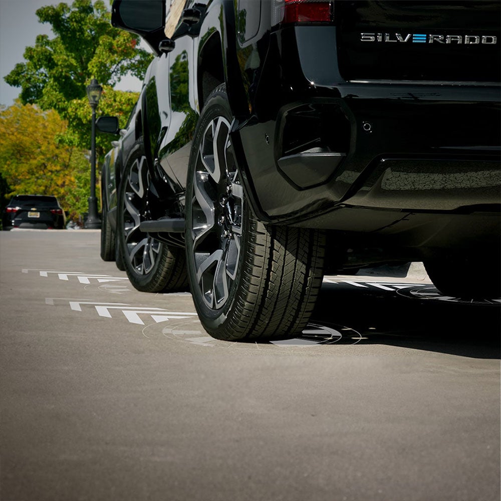 A dealer parking lot, showing a closer up, low view of the cars