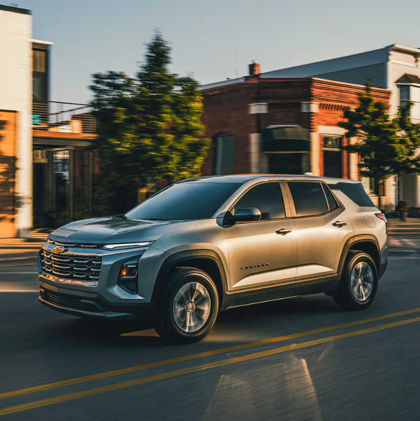 A chevrolet driving down the street 