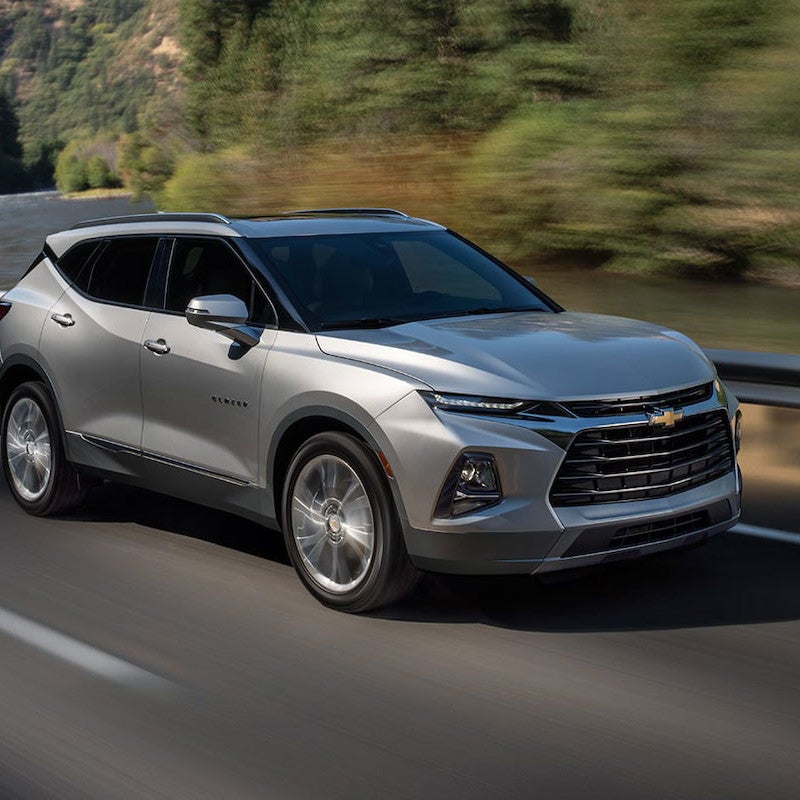 A chevrolet driving down the street 